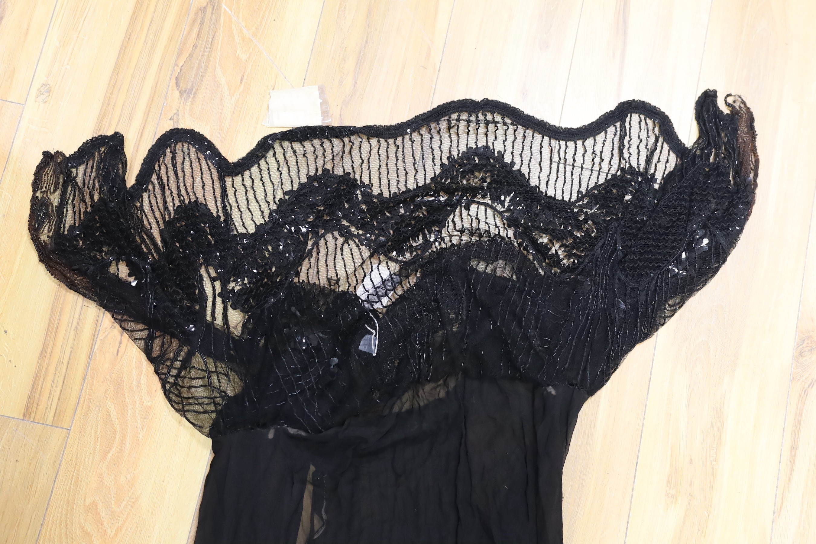 An early 20th century ladies black silk net and chiffon, beaded and sequin evening dress
